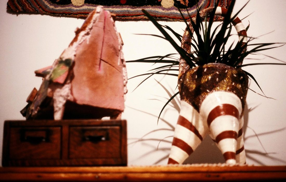 A wooden table with a plant in it